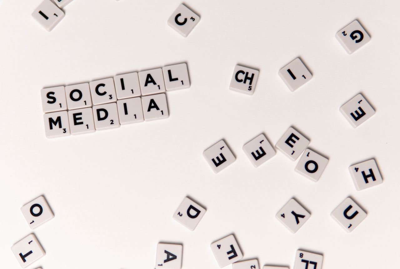 services-01 Scrabble tiles spelling Social Media on a white background, symbolizing digital communication.